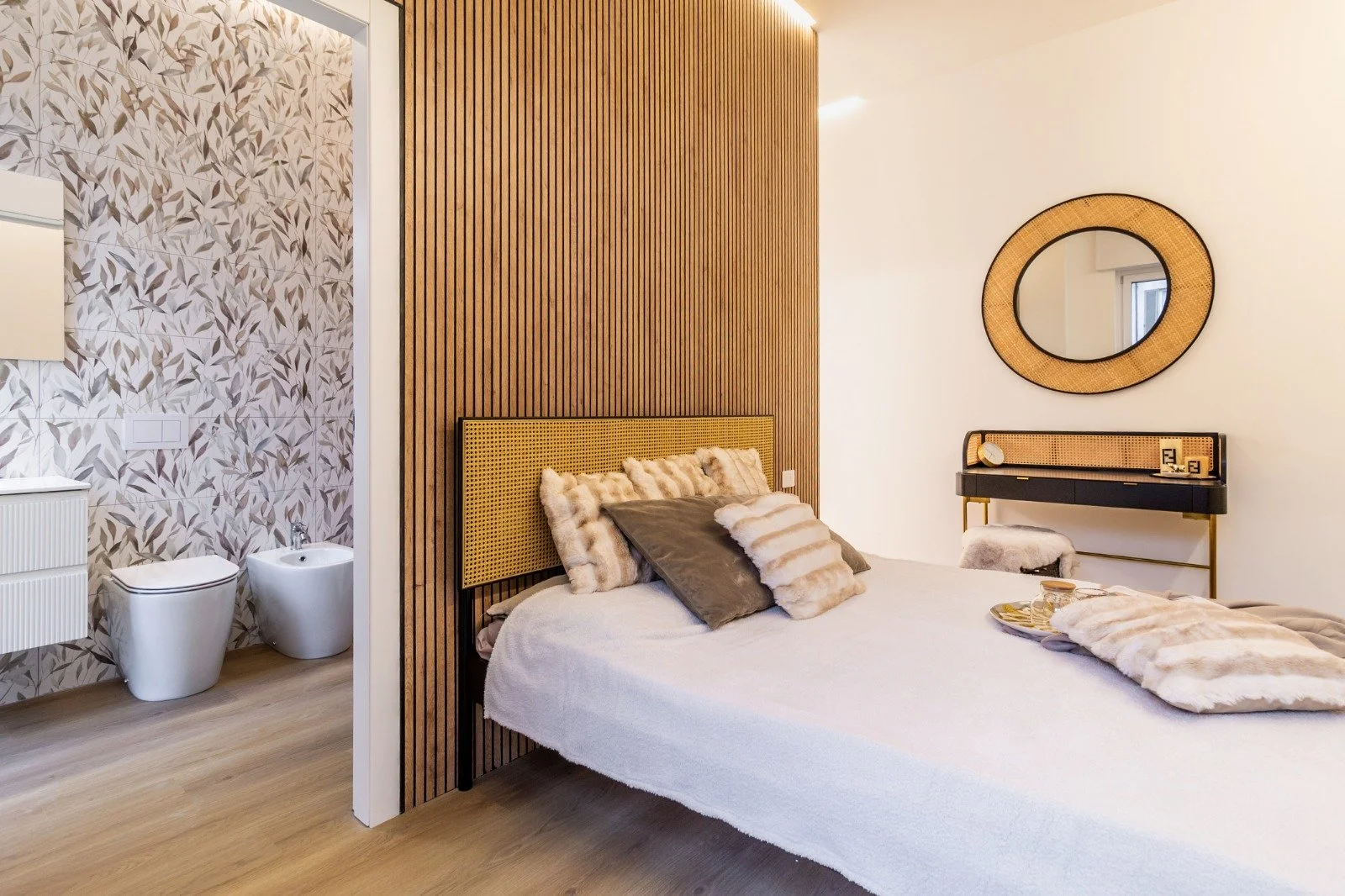 Interior view of a bathroom with a shower, toilet, window, and various cabinets and fixtures.