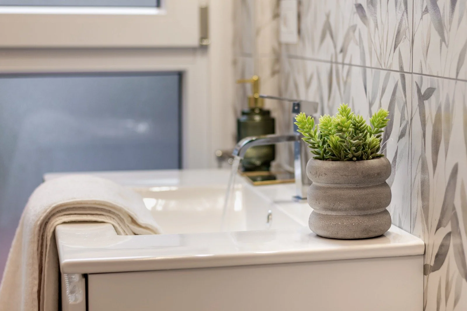 Walk-in closet with white built-in shelves and hanging rods, beige curtains partially covering the space, and wooden flooring.