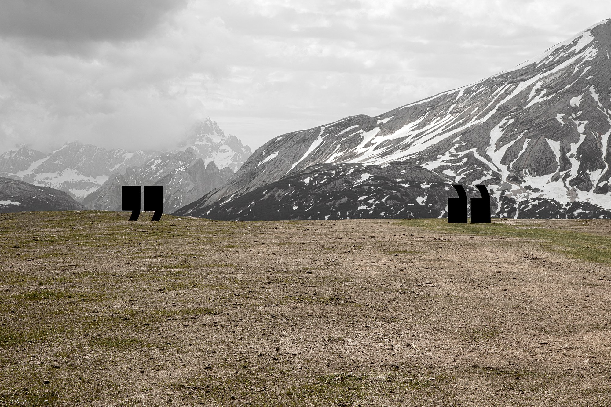 SMACH art "Quotes" by Nazar Bilyk: two giant black quotation mark sculptures stand far apart on a dry alpine ridge against rugged, snow-capped mountains.