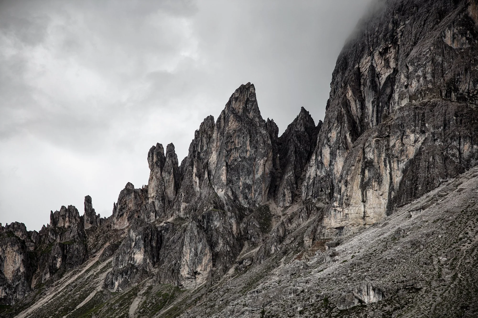 Mountain peaks rise against a cloudy sky.