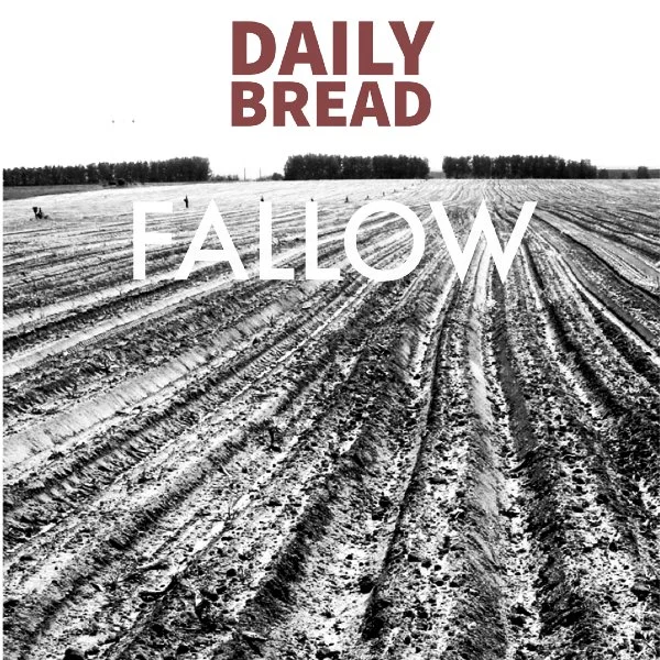 Black and white photo of a plowed field with trees in the background, overlaid with the text "Daily Bread" in red at the top and "Fallow" in white across the middle.