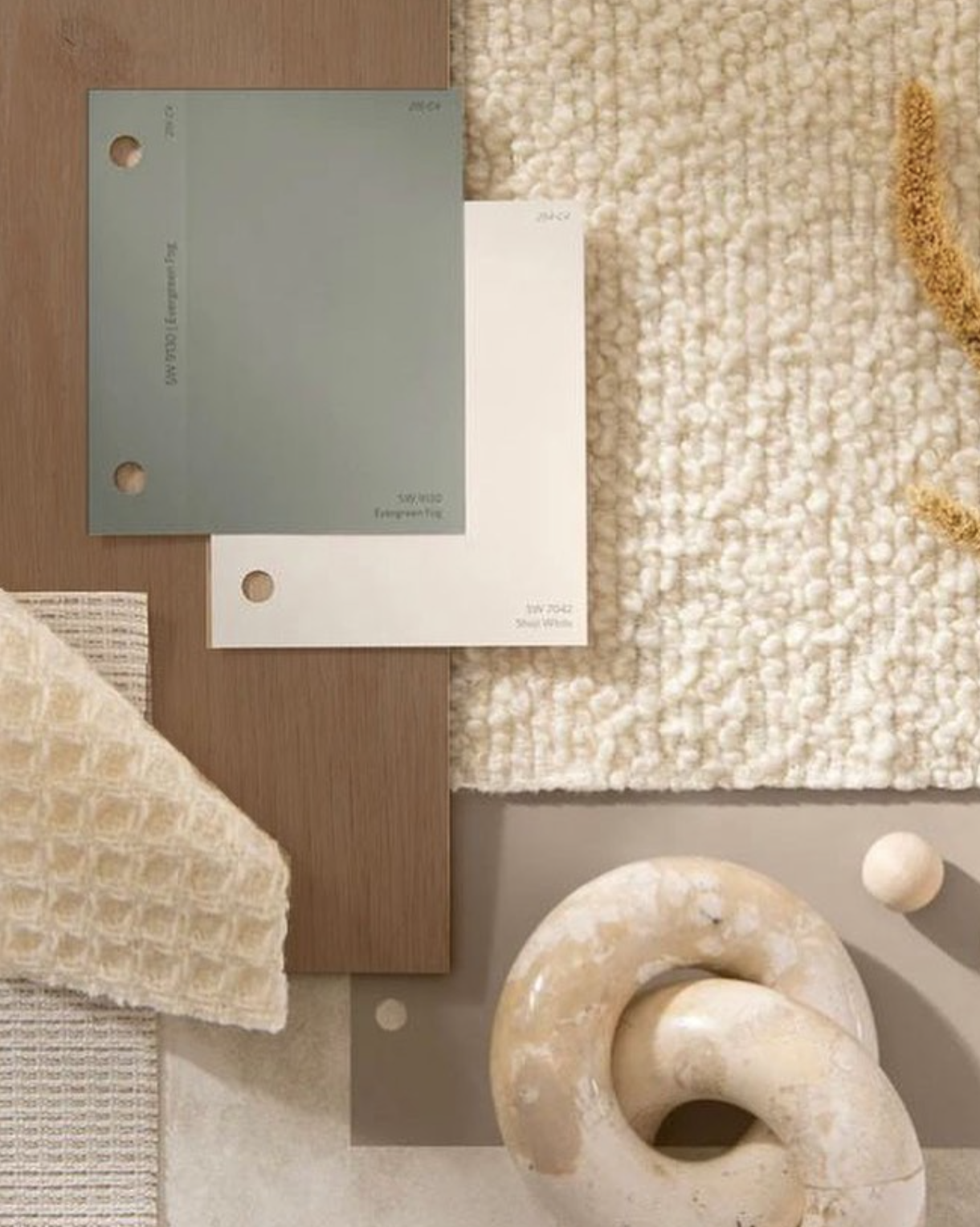 Color palette swatches and fabric samples arranged on a table.