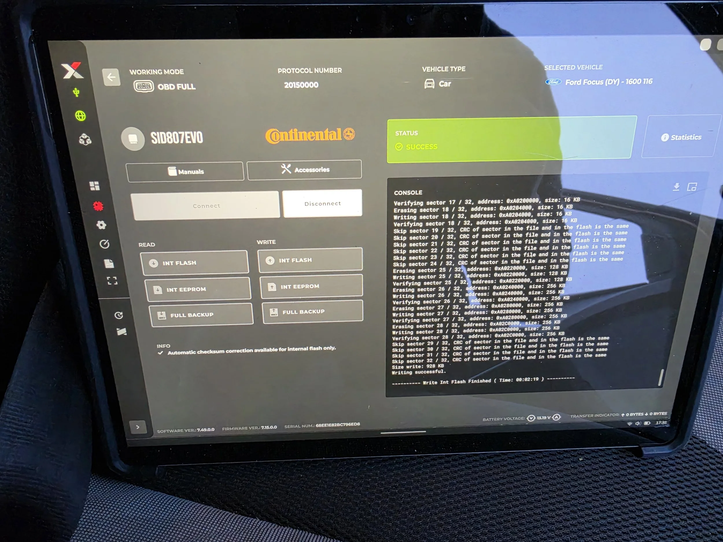 A tablet screen displaying a vehicle diagnostic software interface. The screen shows various technical details, status indicators, and confirmation of a successful process with a green 'Success' label.