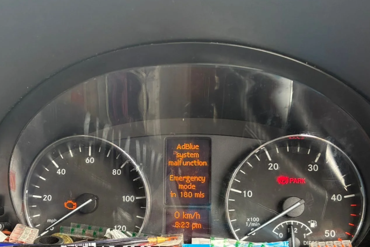 Car dashboard showing a malfunction warning for the AdBlue system, an emergency mode message, Nightfall Automotive tuning and diagnostics