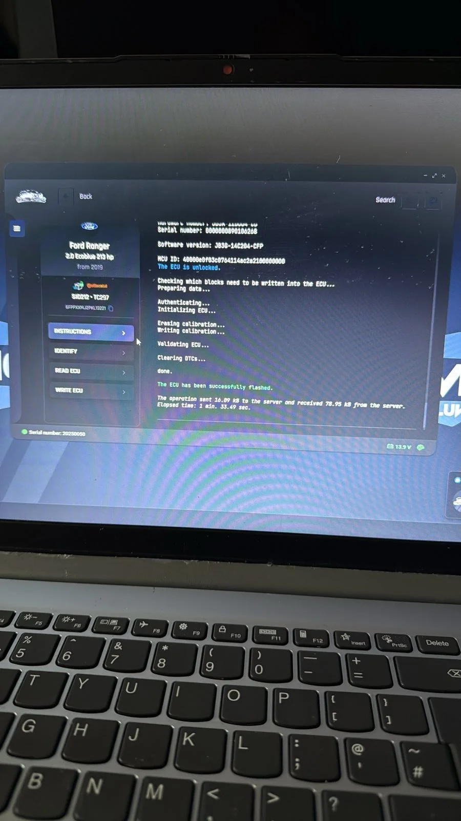 Laptop screen displaying a vehicle's ECU flashing software, showing the process of writing calibration and validation of the ECU for a Ford Ranger 2.0 Ecobuly 213 hp from 2019.