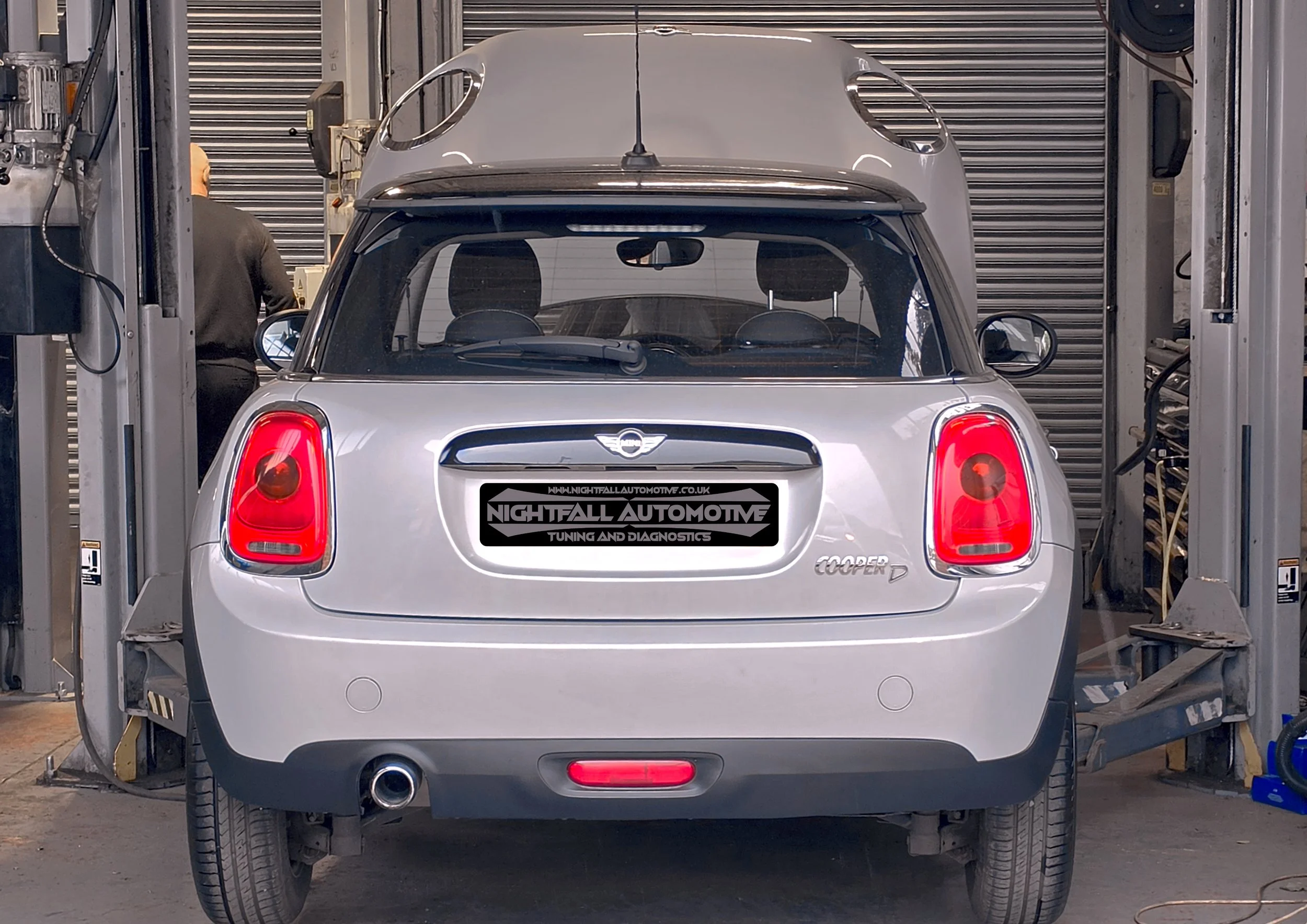 A rear view of a Mini Cooper D car inside a garage Tuned by Nightfall Automotive