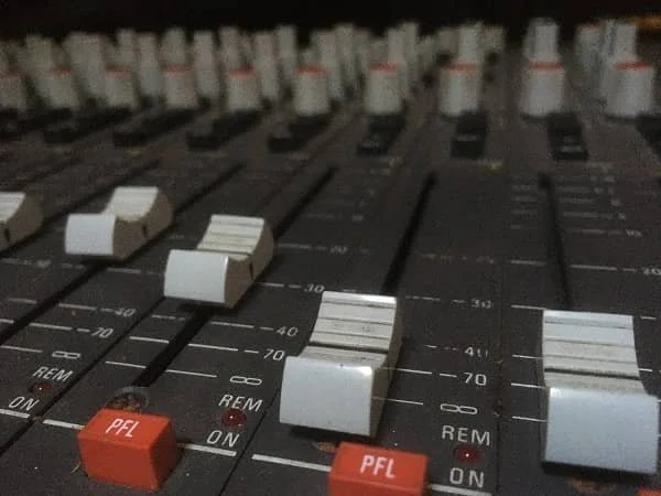 Amec mixing console faders during a music session