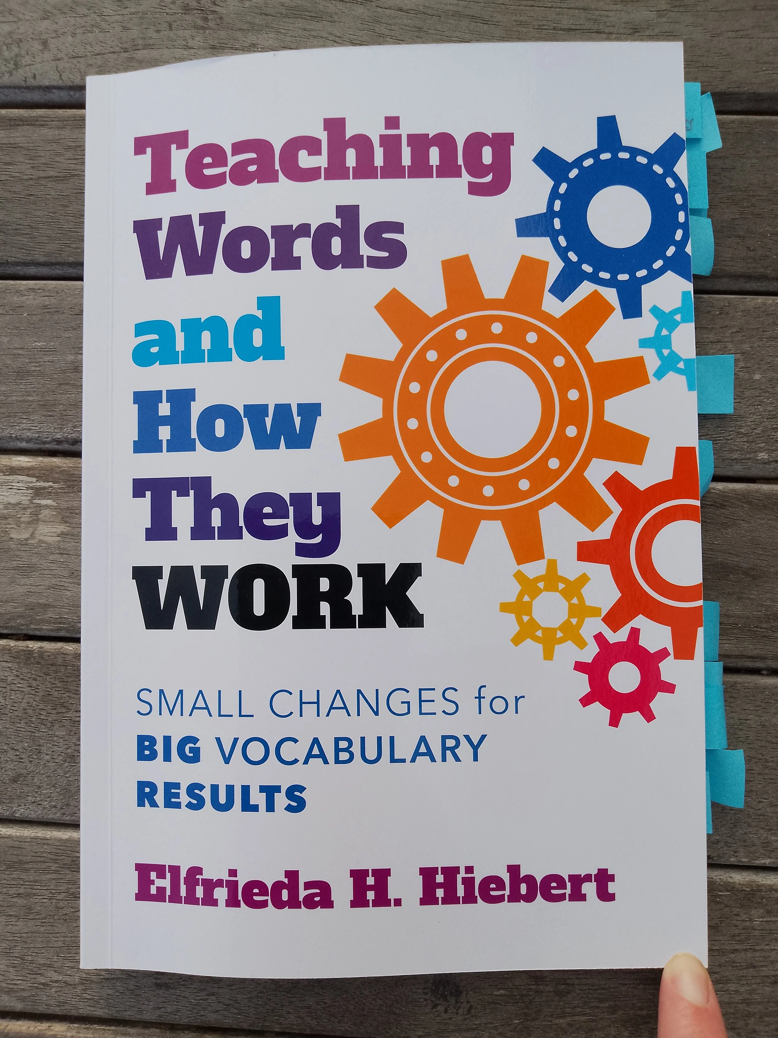 Front cover of Teaching Words and How They Work by Elfrieda Hiebert, showing different size cogs working together. The subtitle is Small Changes for Big Vocabulary Results.