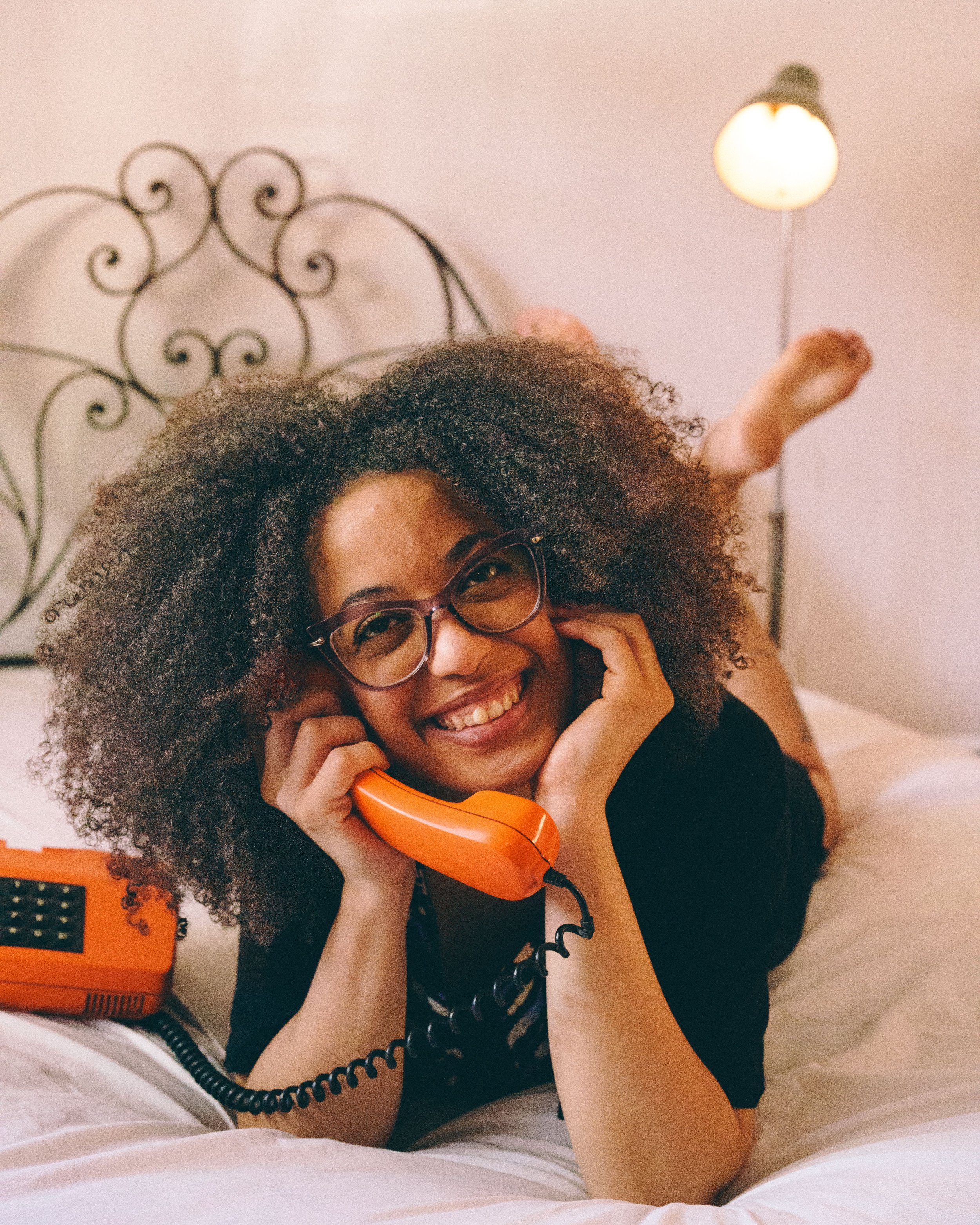 Woman talking on the phone while discussing her skincare and aesthetic treatment options