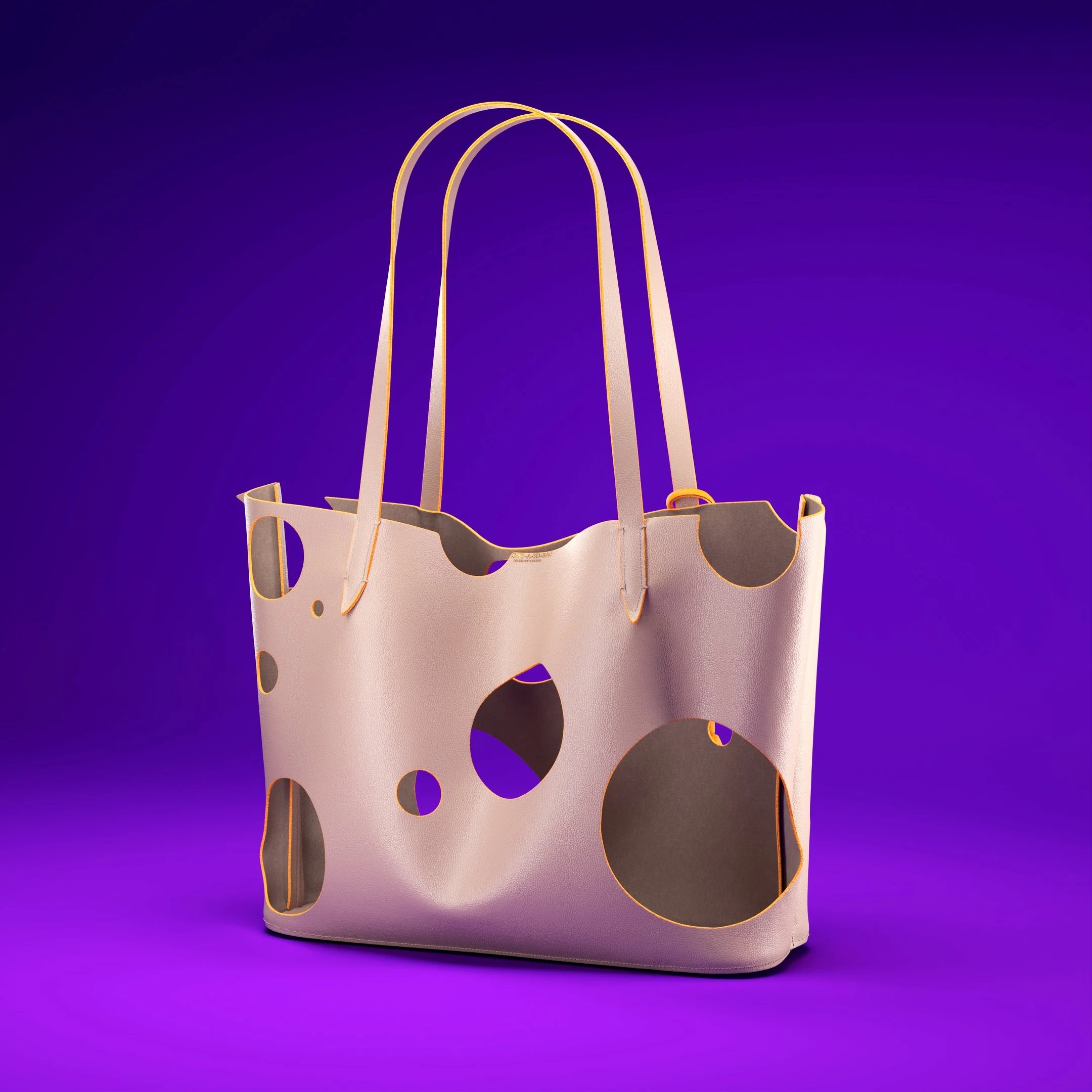 A pink tote bag with large black and yellow circles, set against a purple background.
