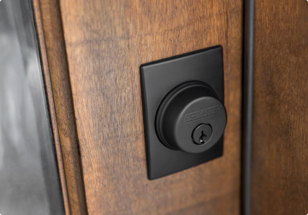 Close-up of a black digital lock on a wooden door.