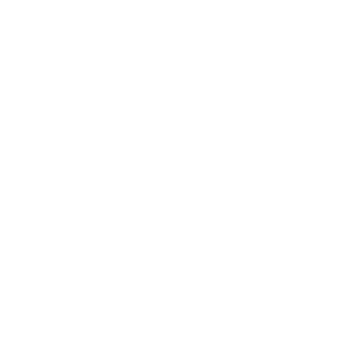 A close-up view of a white cup filled with a dark beverage placed on a coaster on a wooden table.