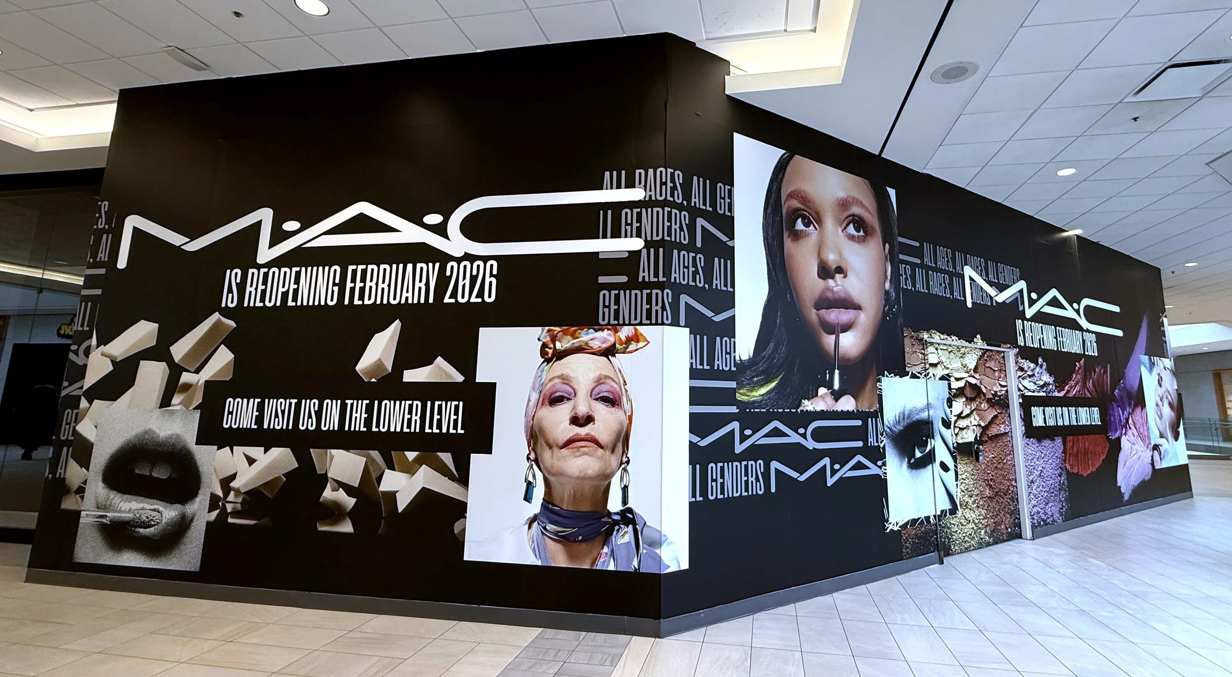Mac Cosmetics store sign announcing reopening in February 2026, with images of diverse women and creative makeup artwork.