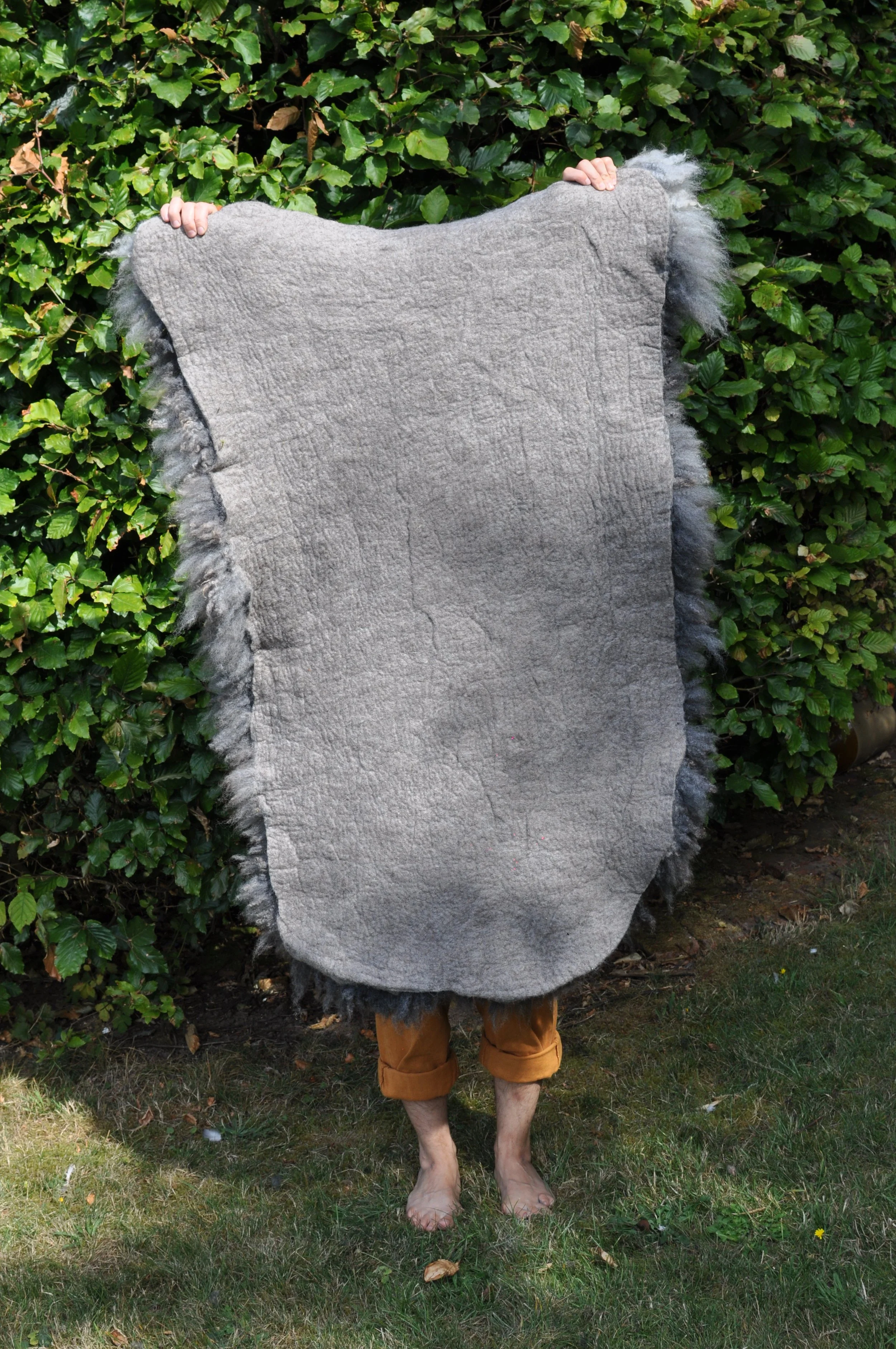 back of felted rug outside