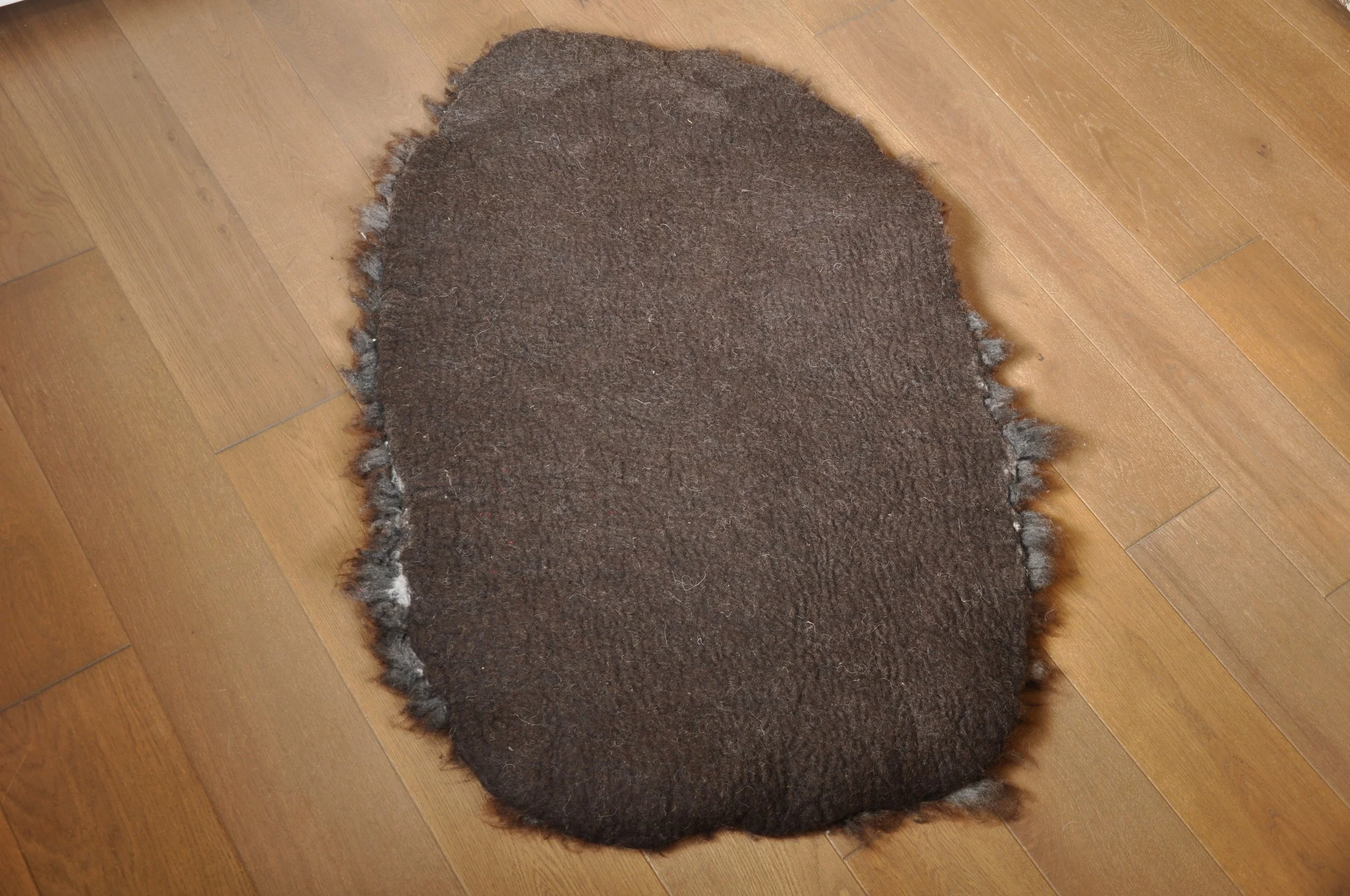 back of felted rug on floor