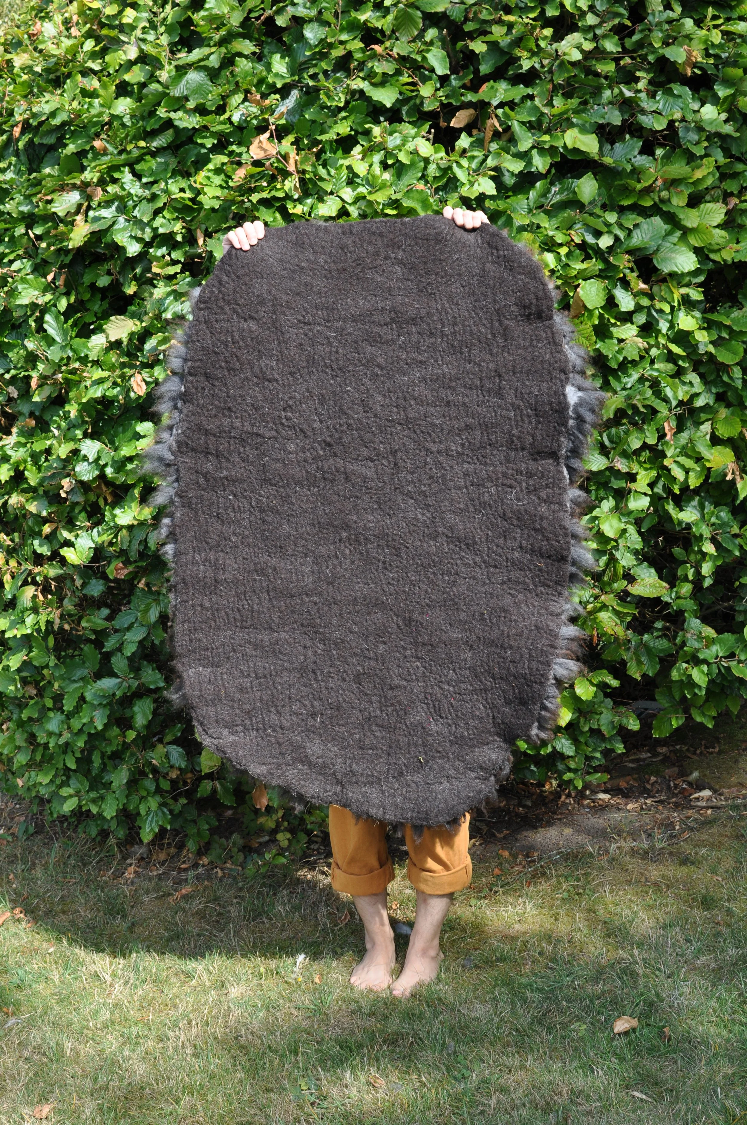 back of felted rug outside