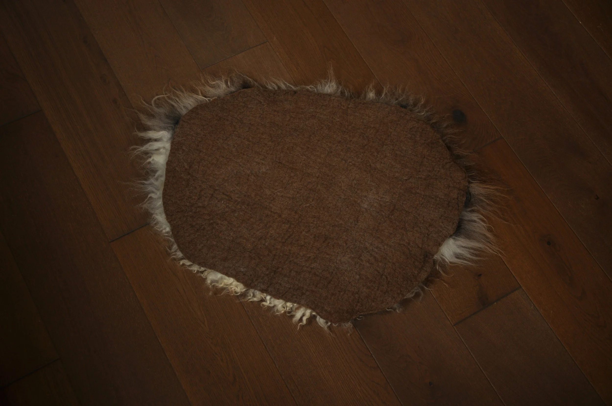 back of felted seat pad on floor