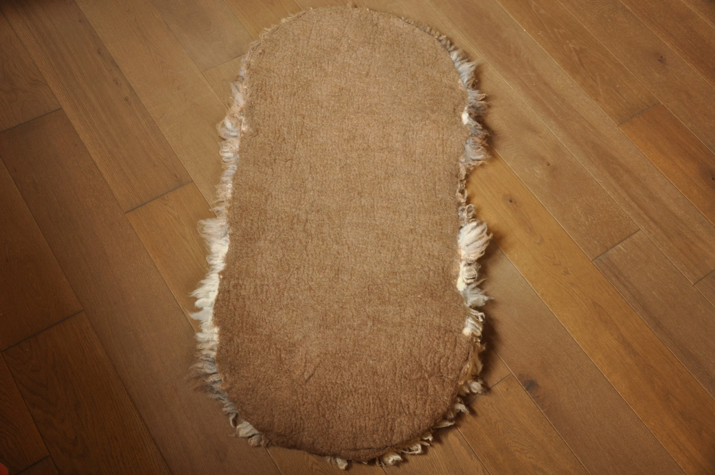 Back of Felted rug on floor