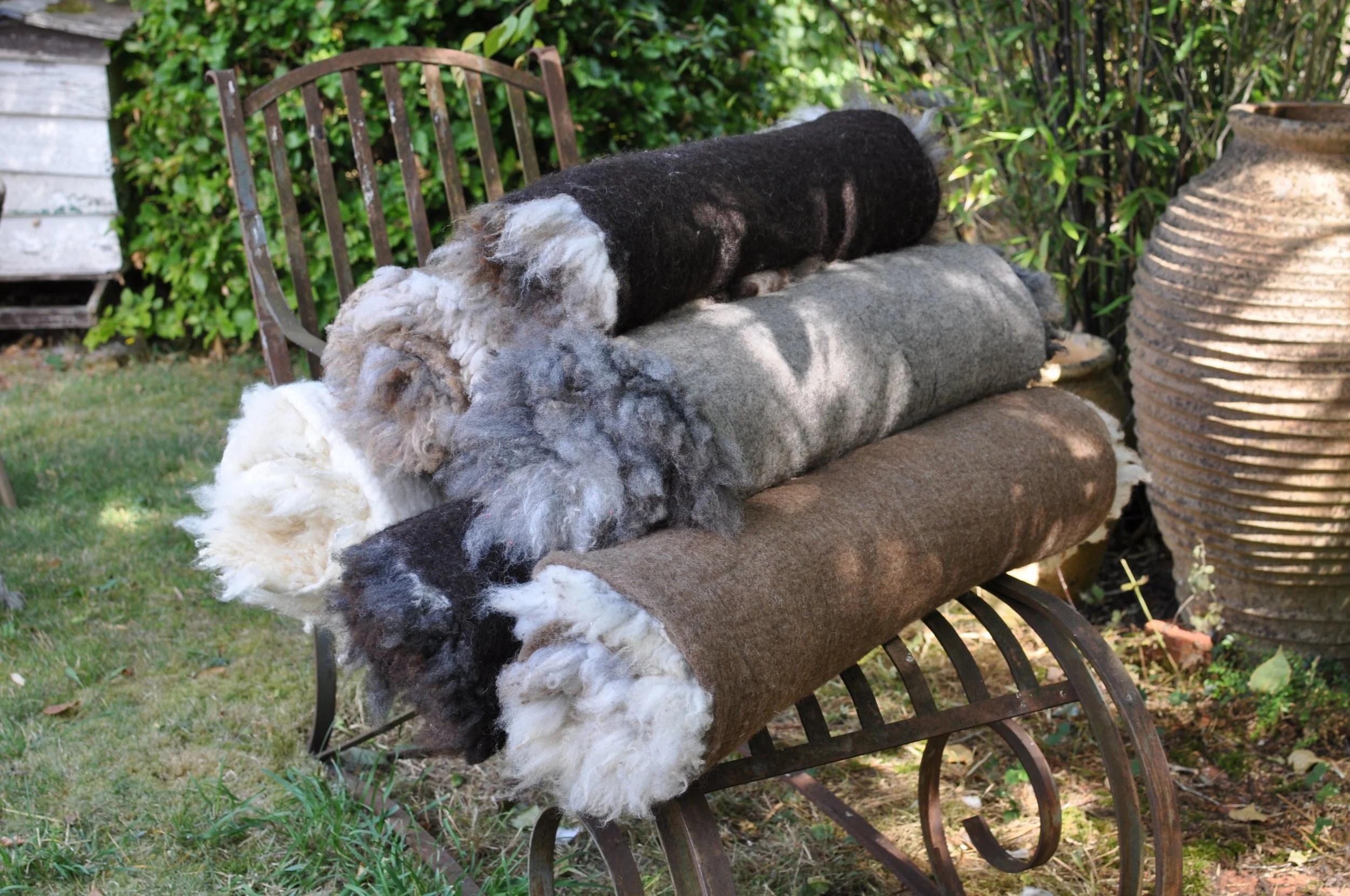 Rolled Felted Sheepskin Rugs on an iron garden chair