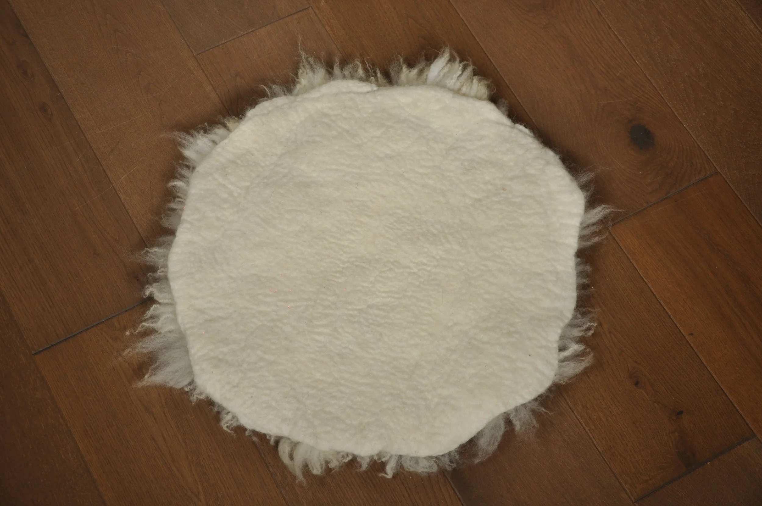 Back of felted seat pad on floor