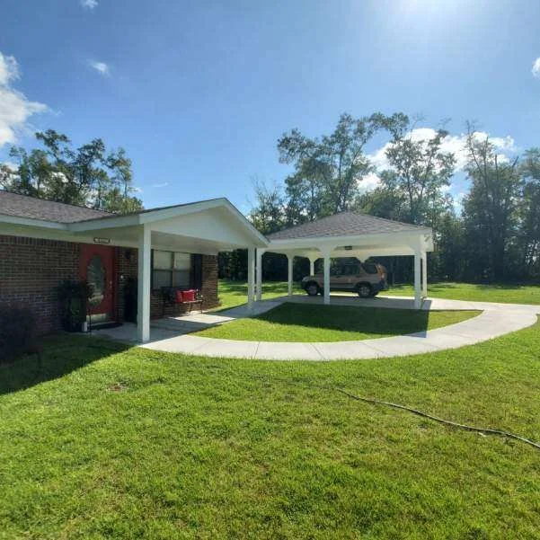 Completed residential home featuring a covered porch and free-standing carport constructed by Tindall Construction.