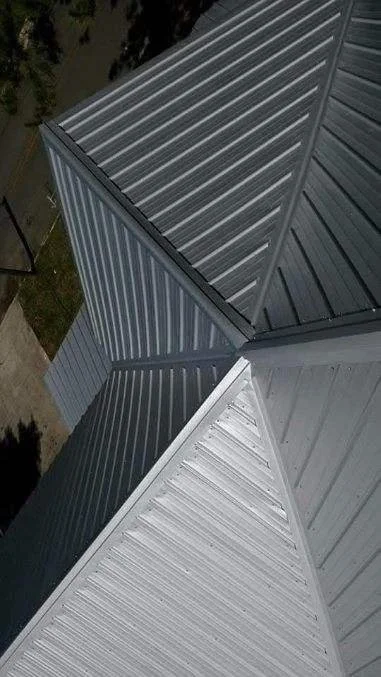 Close-up detail of standing seam metal roofing panels installed by Tindall Construction.