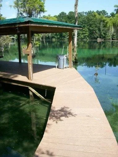 Custom wooden dock and covered pavilion constructed by Tindall Construction on a residential lakefront.