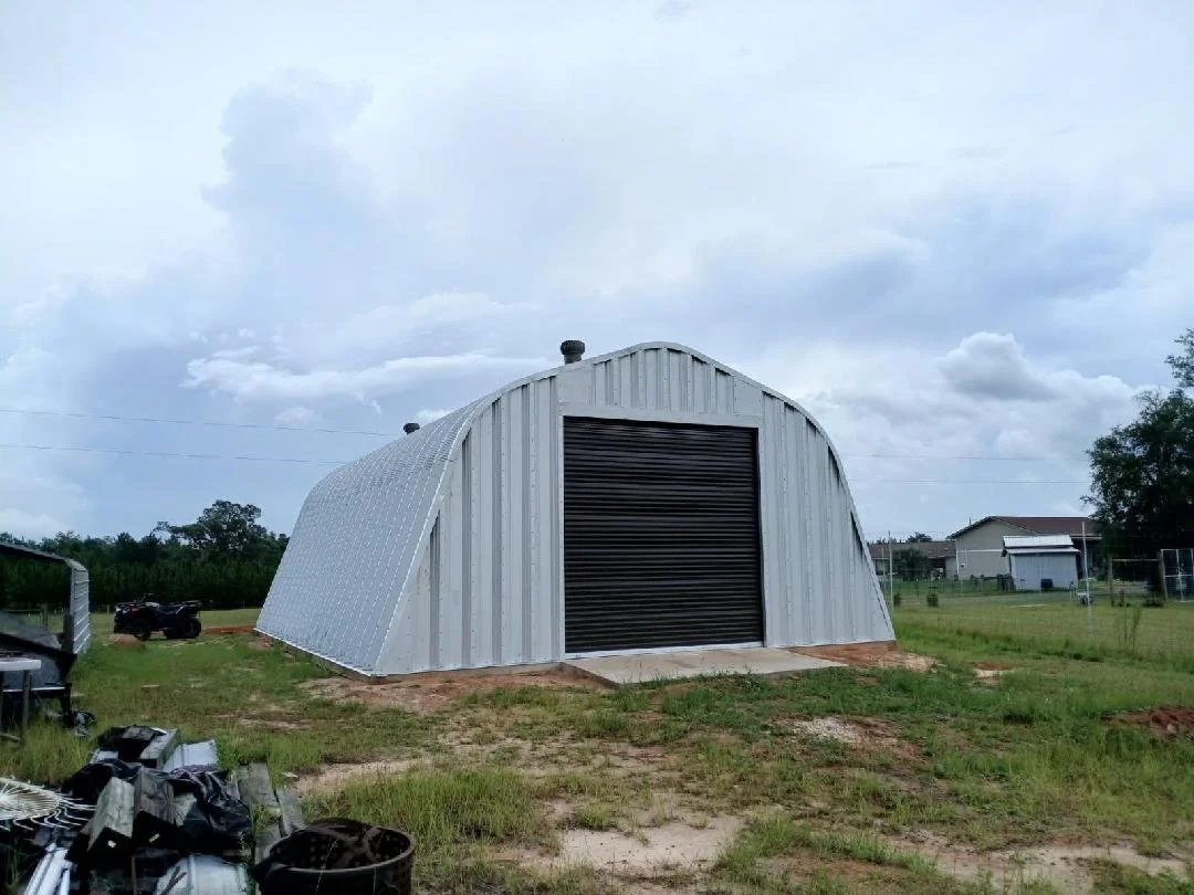 Completed Quonset-style metal building with roll-up door constructed by Tindall Construction.