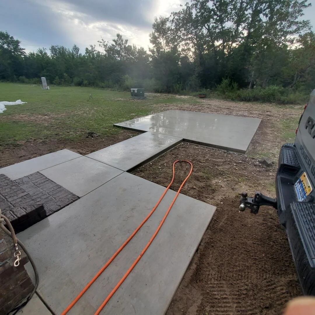 New concrete sidewalk and patio installation completed as part of a residential construction project by Tindall Construction.