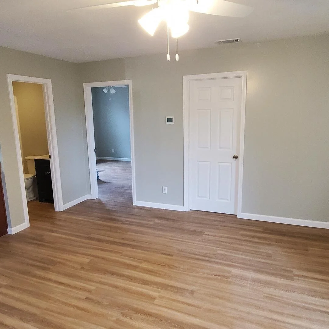 Finished residential interior featuring hardwood flooring and updated living space by Tindall Construction.