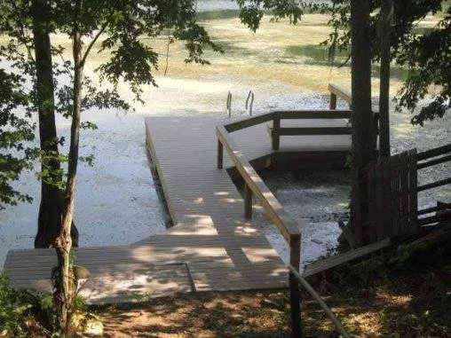 Wooden dock and access ramp constructed by Tindall Construction for a residential lakefront property.