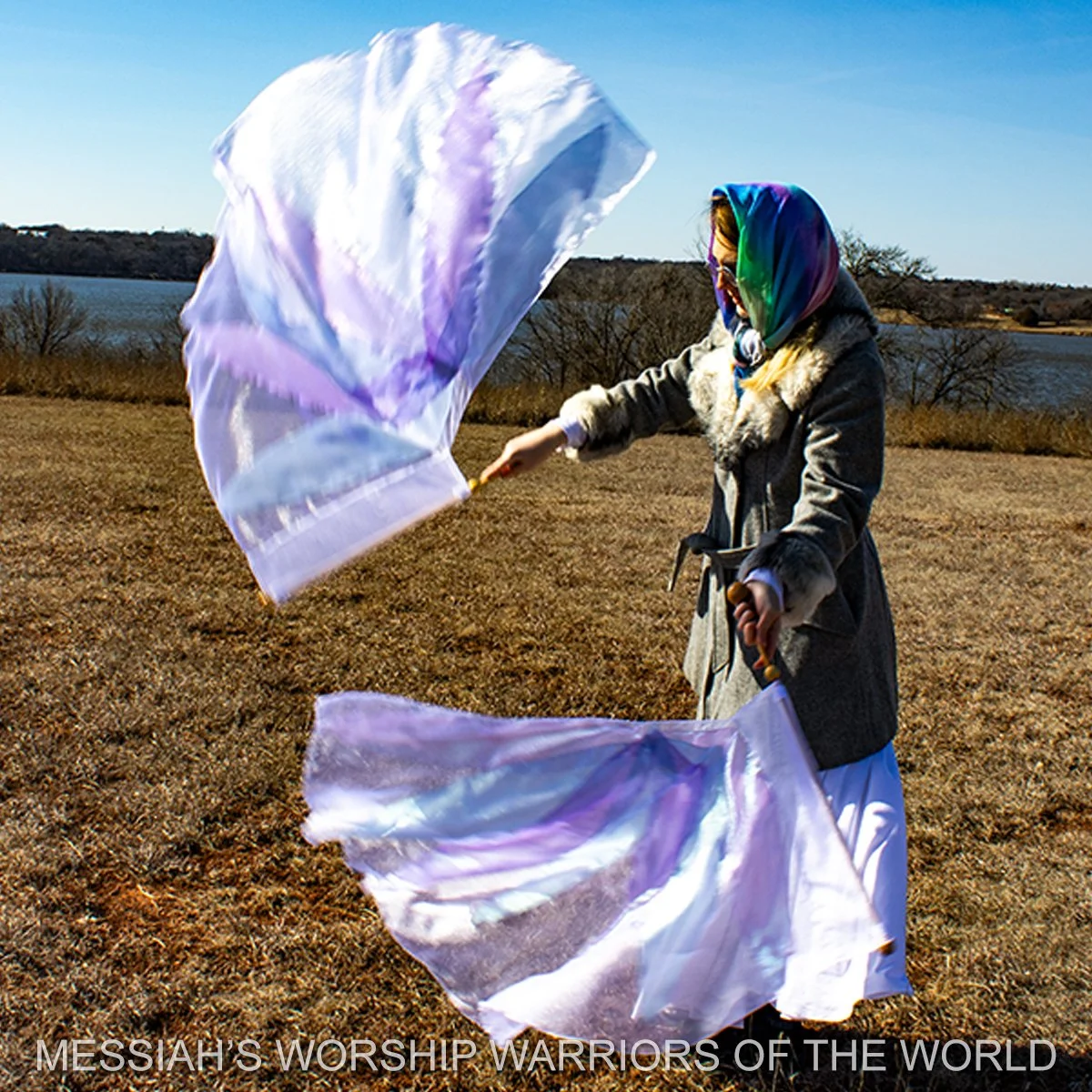 Spin-Tube worship flags in motion with the image of a lily on them to represent how God provides for the lilies of the field in the same way He does for us.