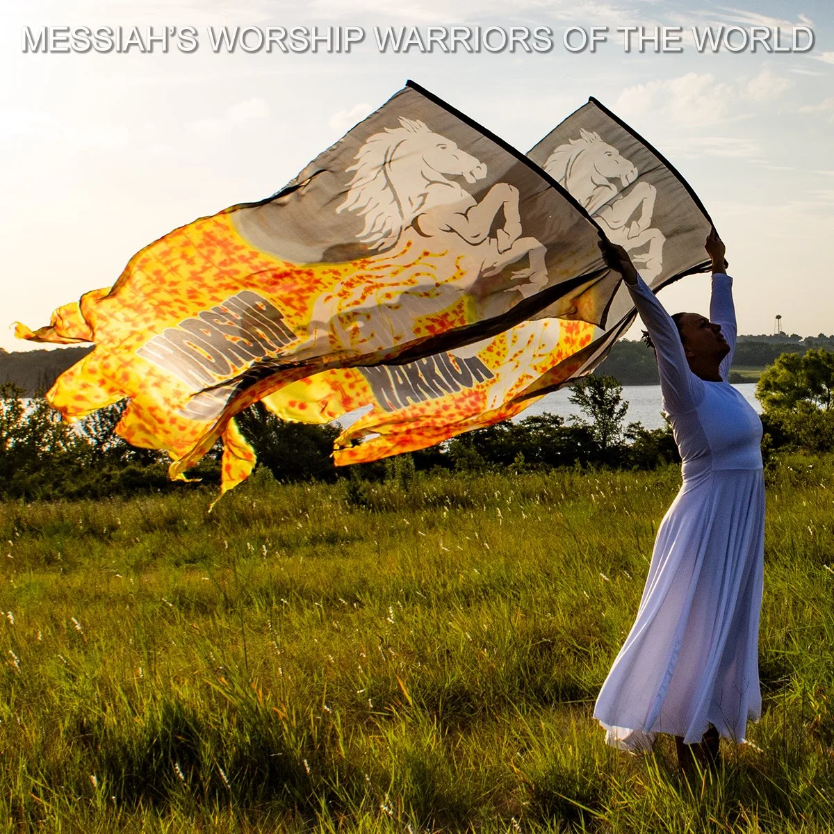 Hand Painted Silk Worship Flags with the image of a white horse bringing in the fire of God and the words Worship Warrior behind it.