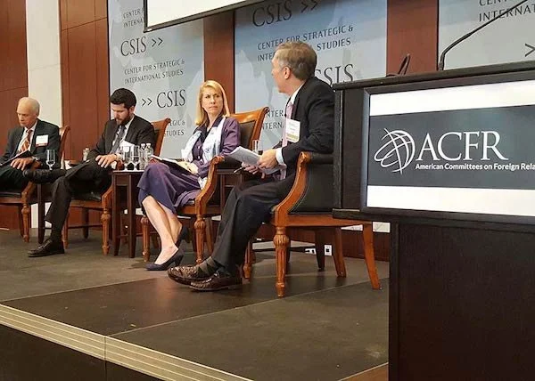 Five people sitting on a panel at a conference, with a backdrop displaying 'CSIS' and 'Center for Strategic & International Studies,' and a podium labeled 'ACFR' for American Committees on Foreign Relations.
