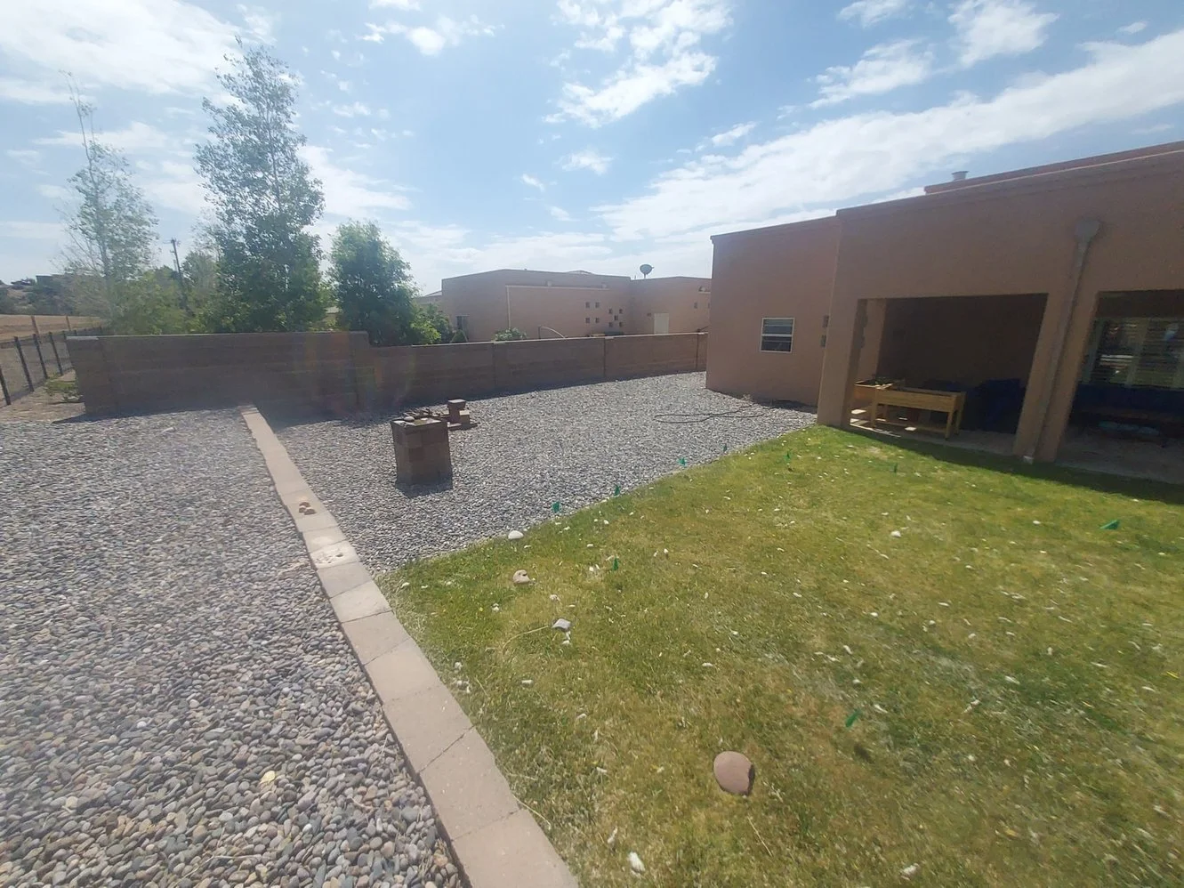 Low-maintenance gravel yard installed by Priddy Landscaping and Irrigation on Rancho De Animas Drive in Farmington NM