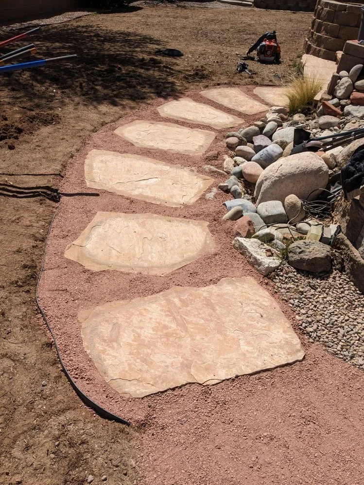 Low-maintenance gravel yard installed by Priddy Landscaping and Irrigation on Rancho De Animas Drive in Farmington NM