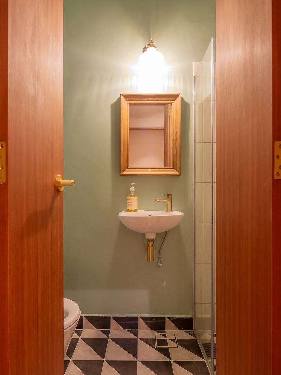 art deco interior design Singapore, black and white tiled bathrooms, green bathrooms, shophouse design and renovation