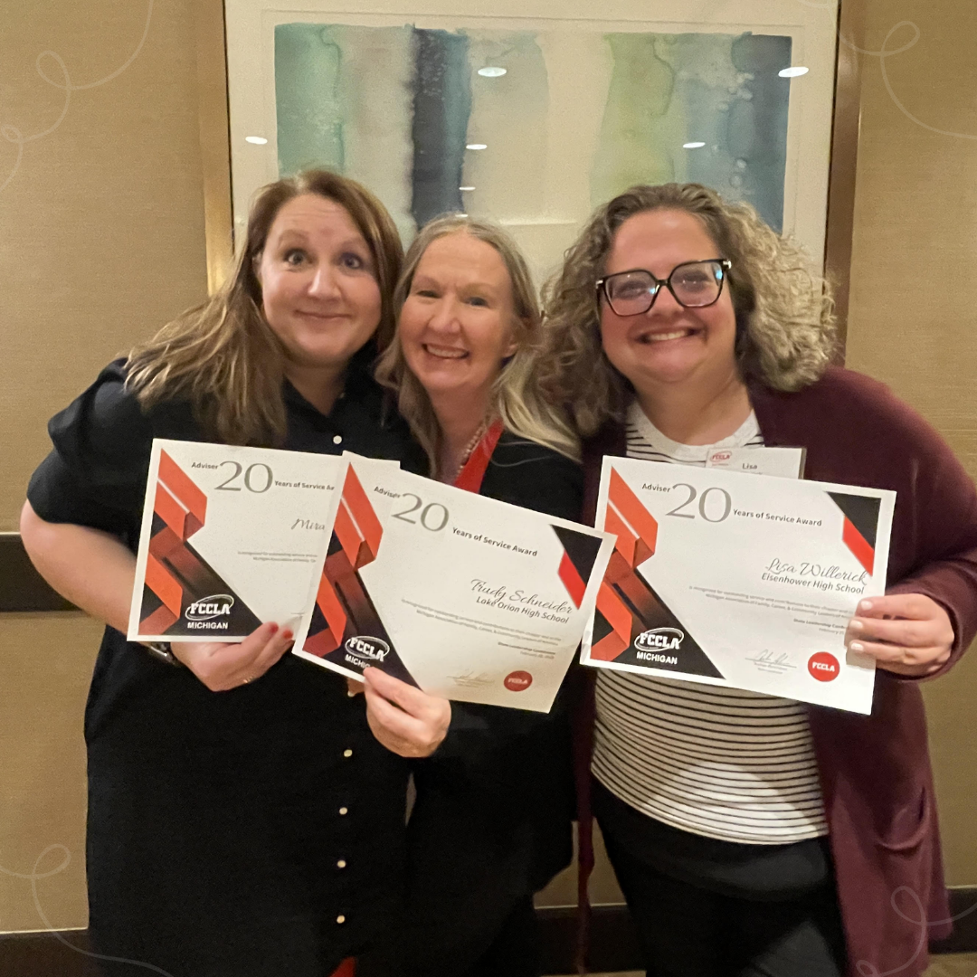 Three FCCLA advisers holding up certificates recognizing them for 20 years of service.