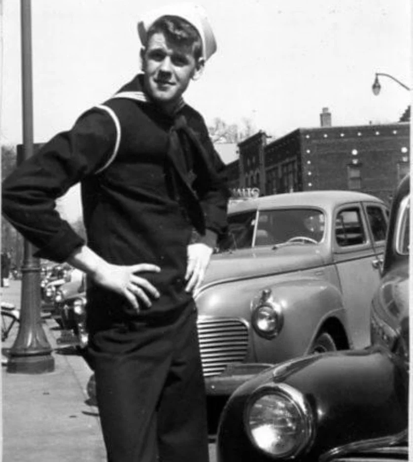 A U.S. Navy sailor poses for a portrait outside the Rialto Theatre, circa 1940s.
