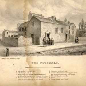 A black and white illustration of a historic building labeled 'The Foundrey,' showing a stone structure with a few people standing outside, some with hats and clothing typical of the past, in front of a street scene.