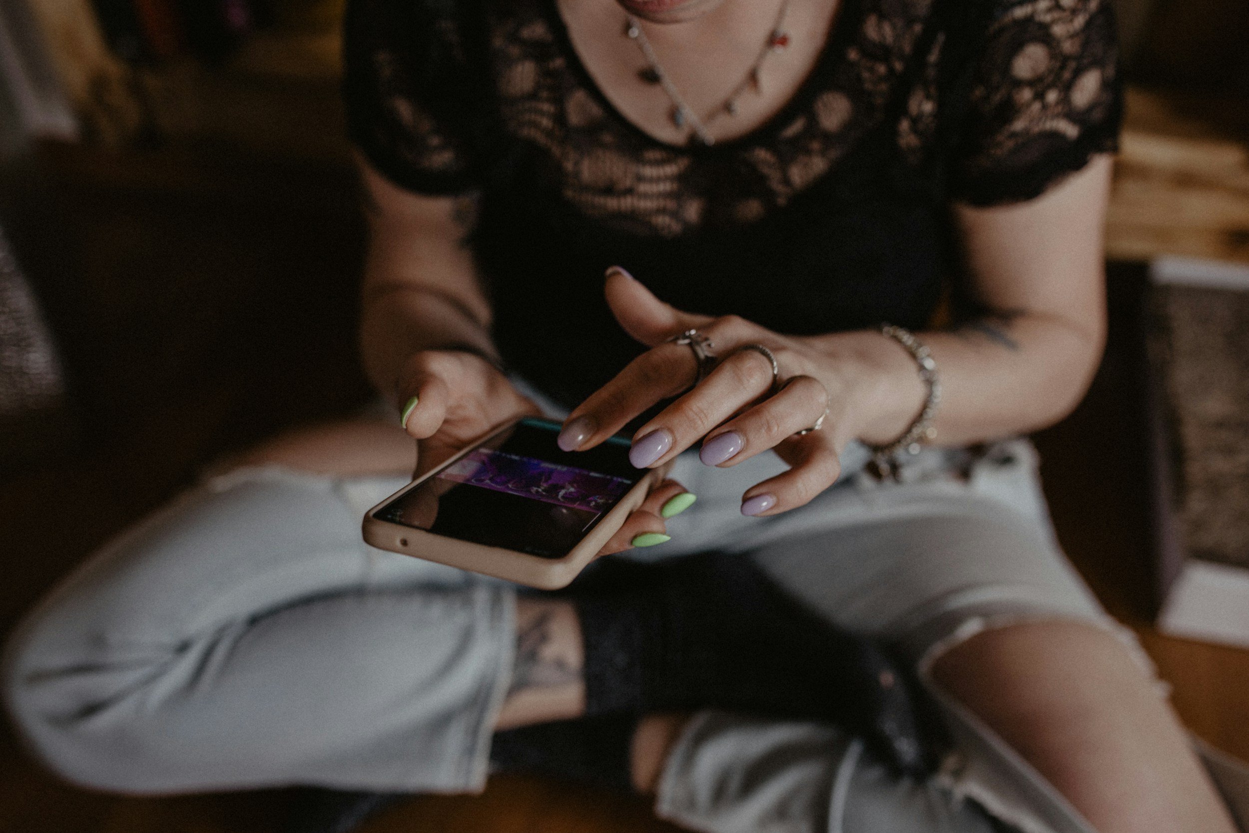 Potential client scrolling on phone to try to find a therapist in Edmonton.