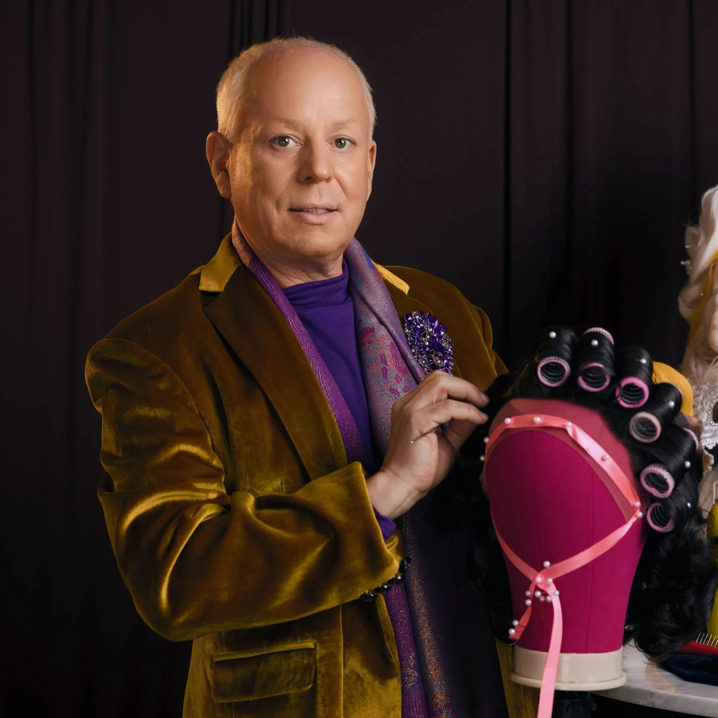 Andre Hopper in brown velvet suit and purple shirt