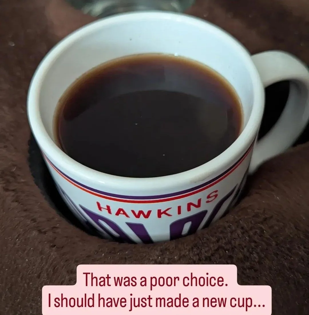 A coffee mug full of coffee. Weak coffee.