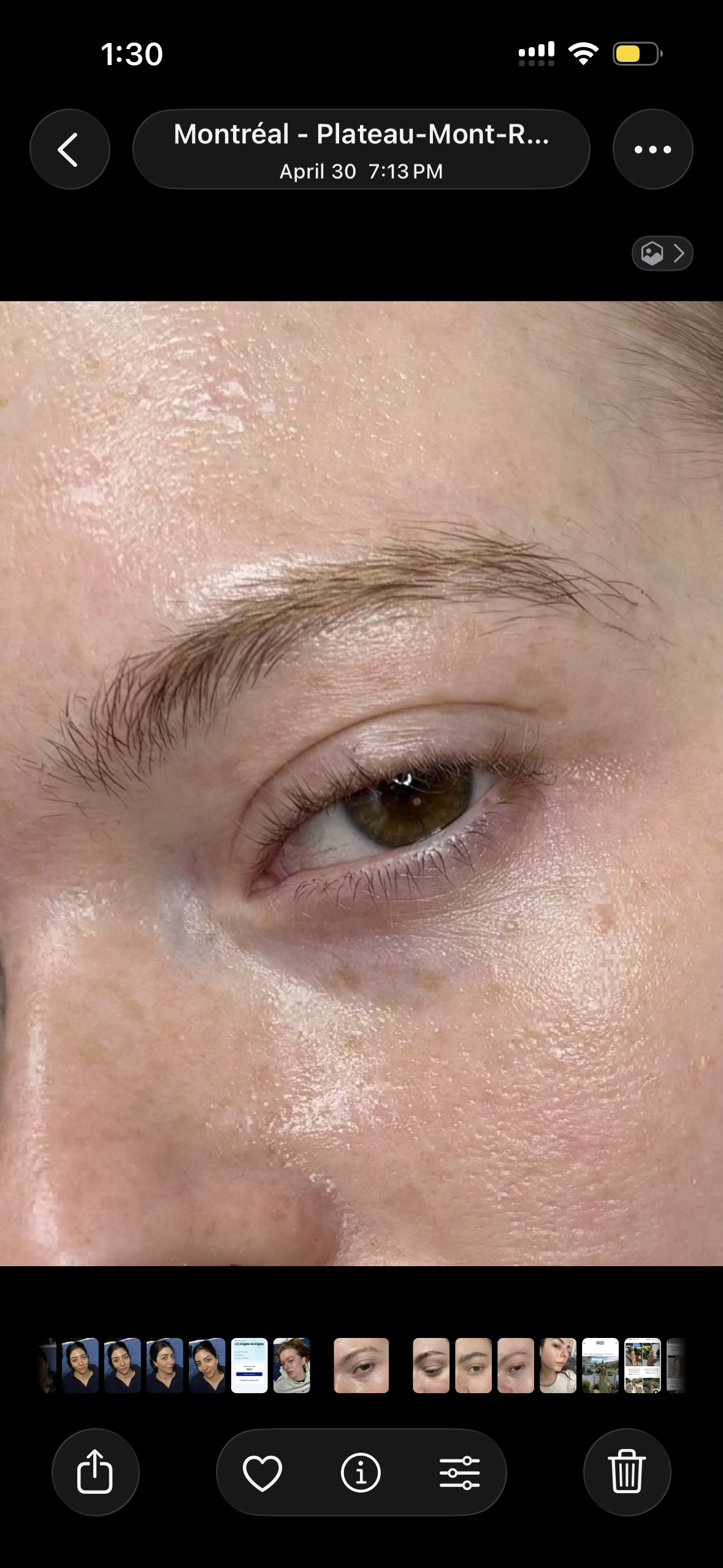 Close-up of a person's eye and eyebrow with clear skin and natural makeup.