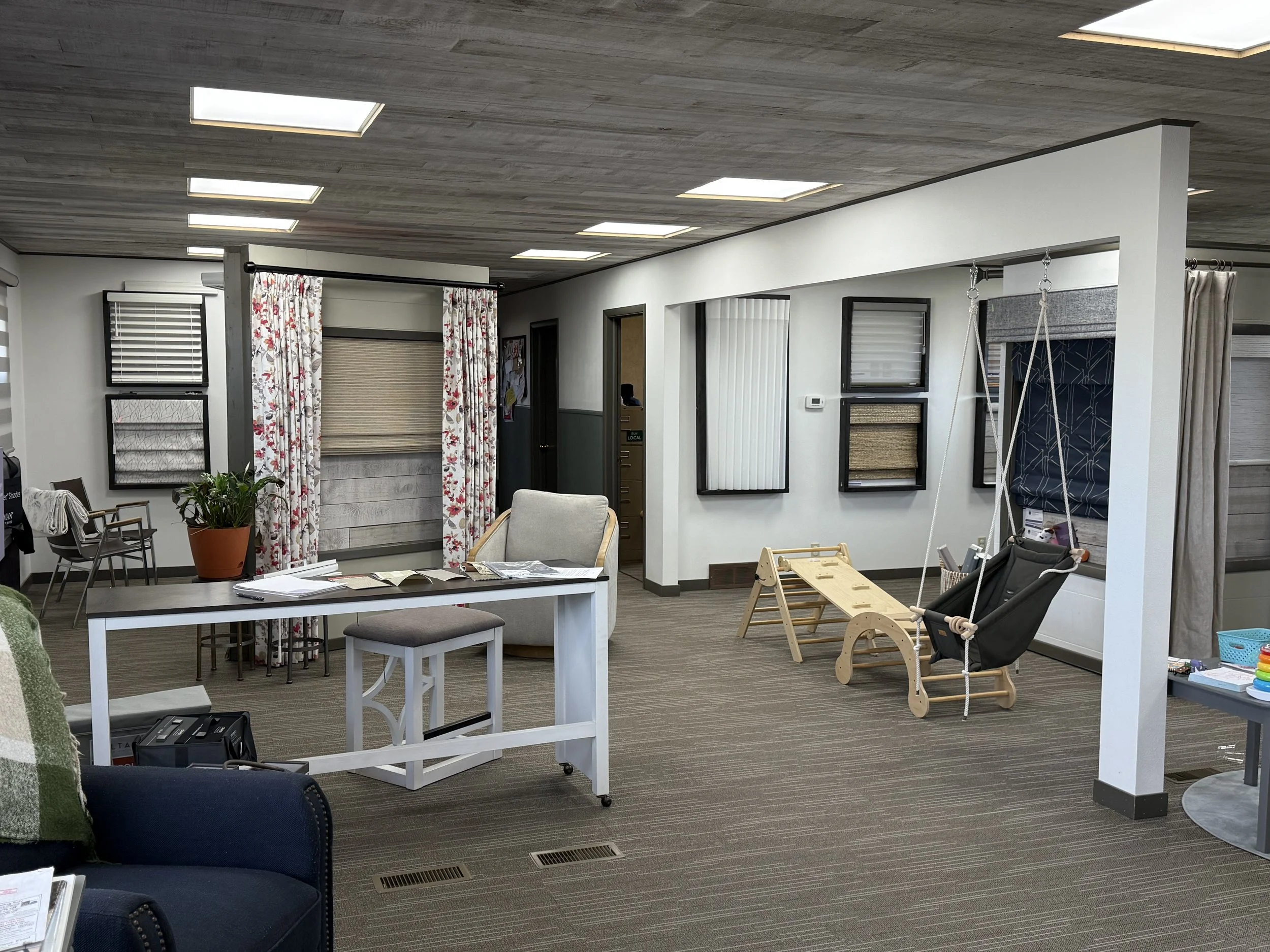 Showroom shot including pikler and swing play area.