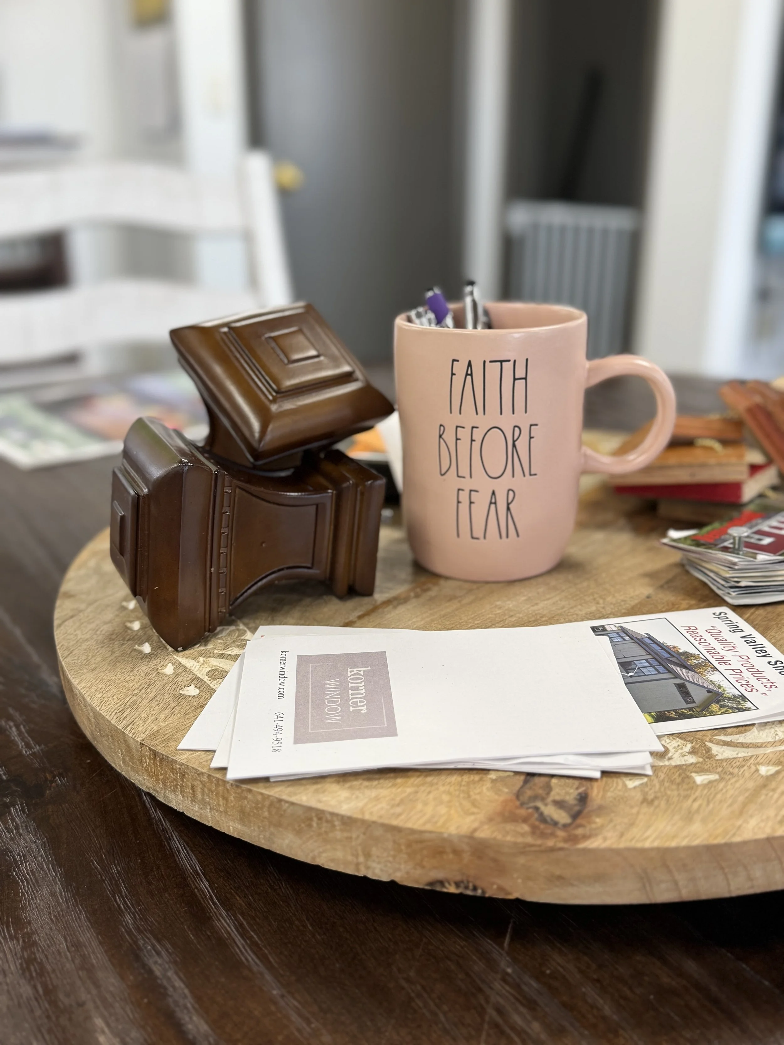 Faith Before Fear mug on sales table.