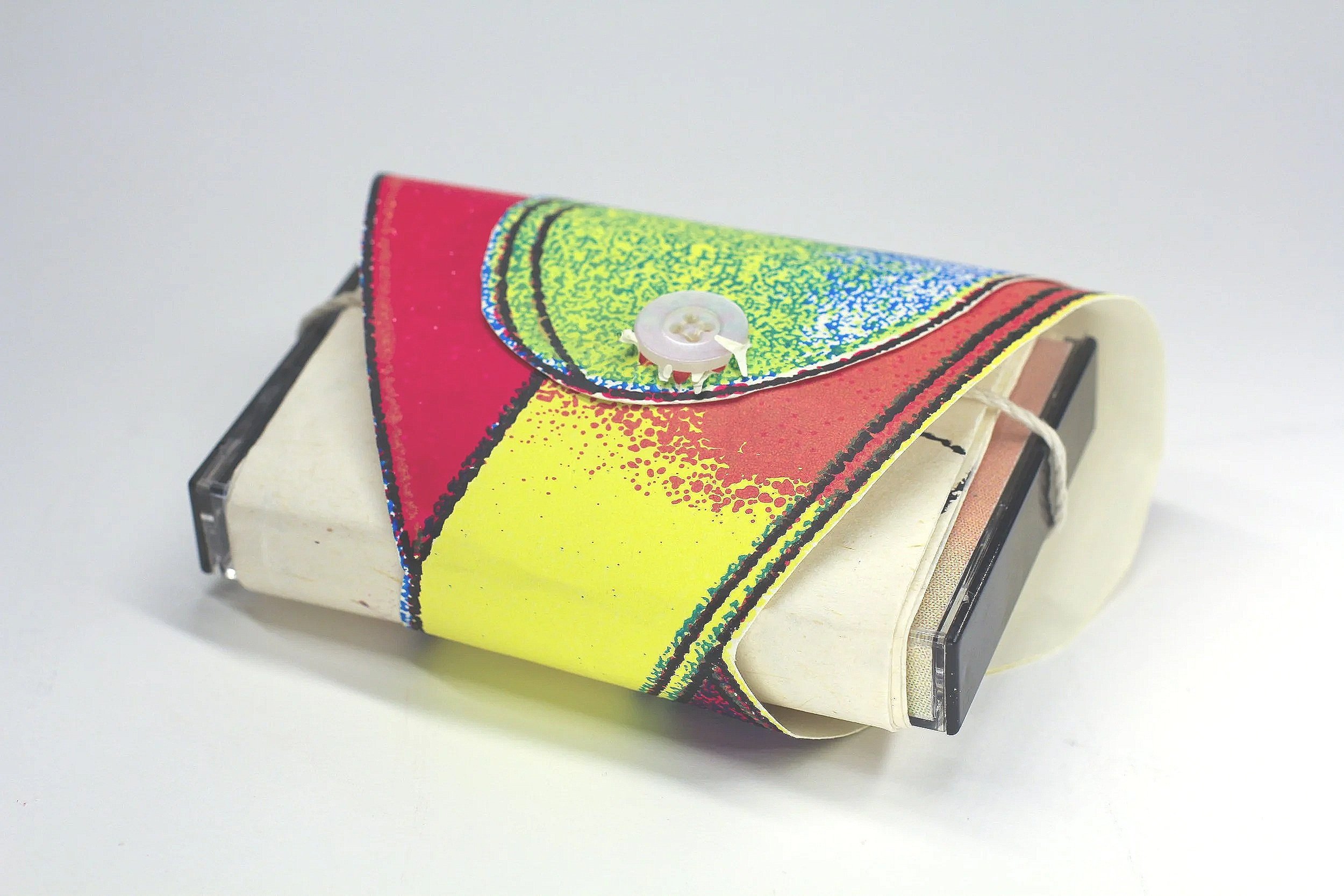 Light Loops by Alex Huang and Lily Campbell - 

Detail view of full package with bound outer sleeve and buttoned mobius strip exterior