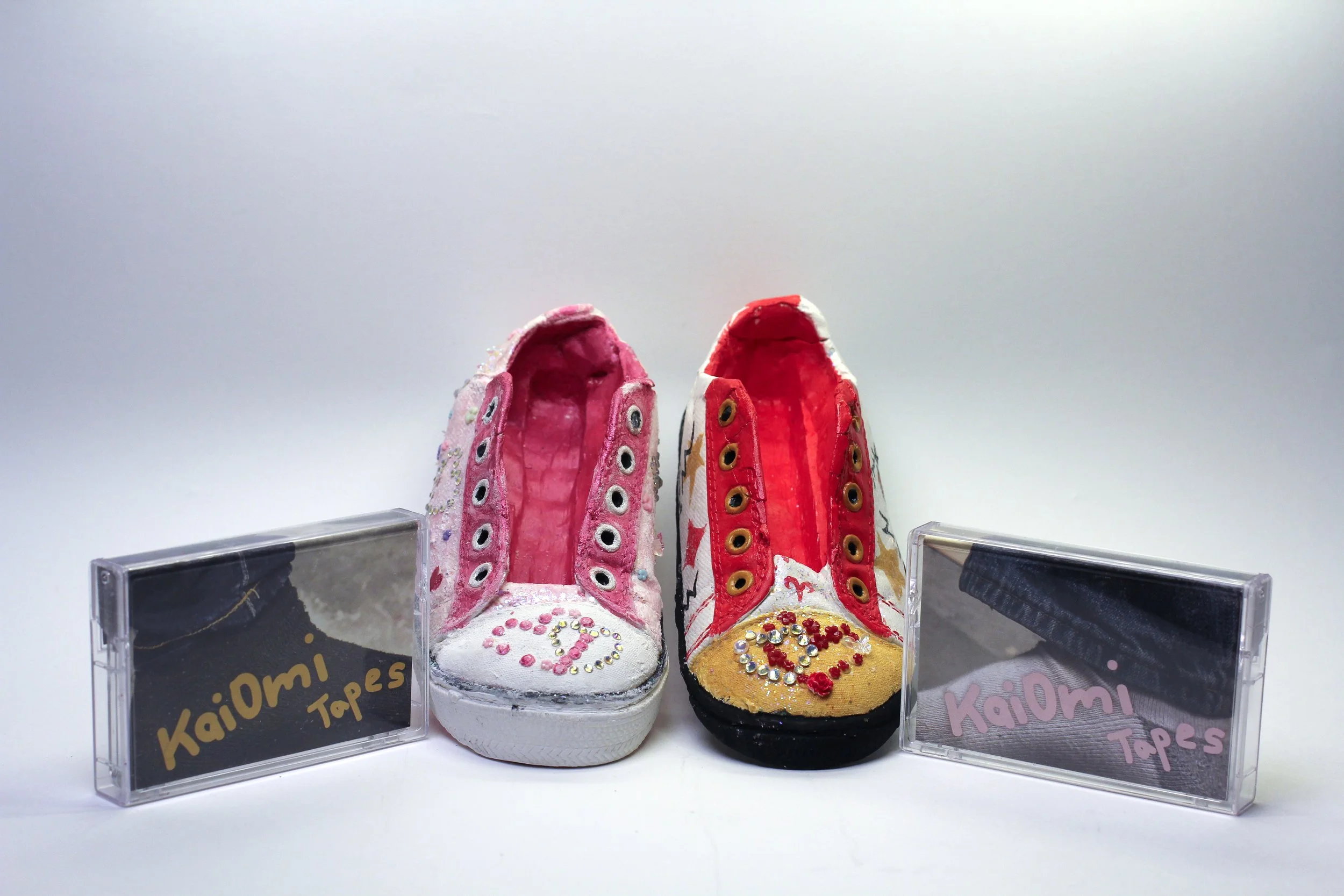 KaiOmi Tapes by Naomi Knight and Kai Chen -

Detail front view of the both shoes and the cassette tapes featuring the artists socks