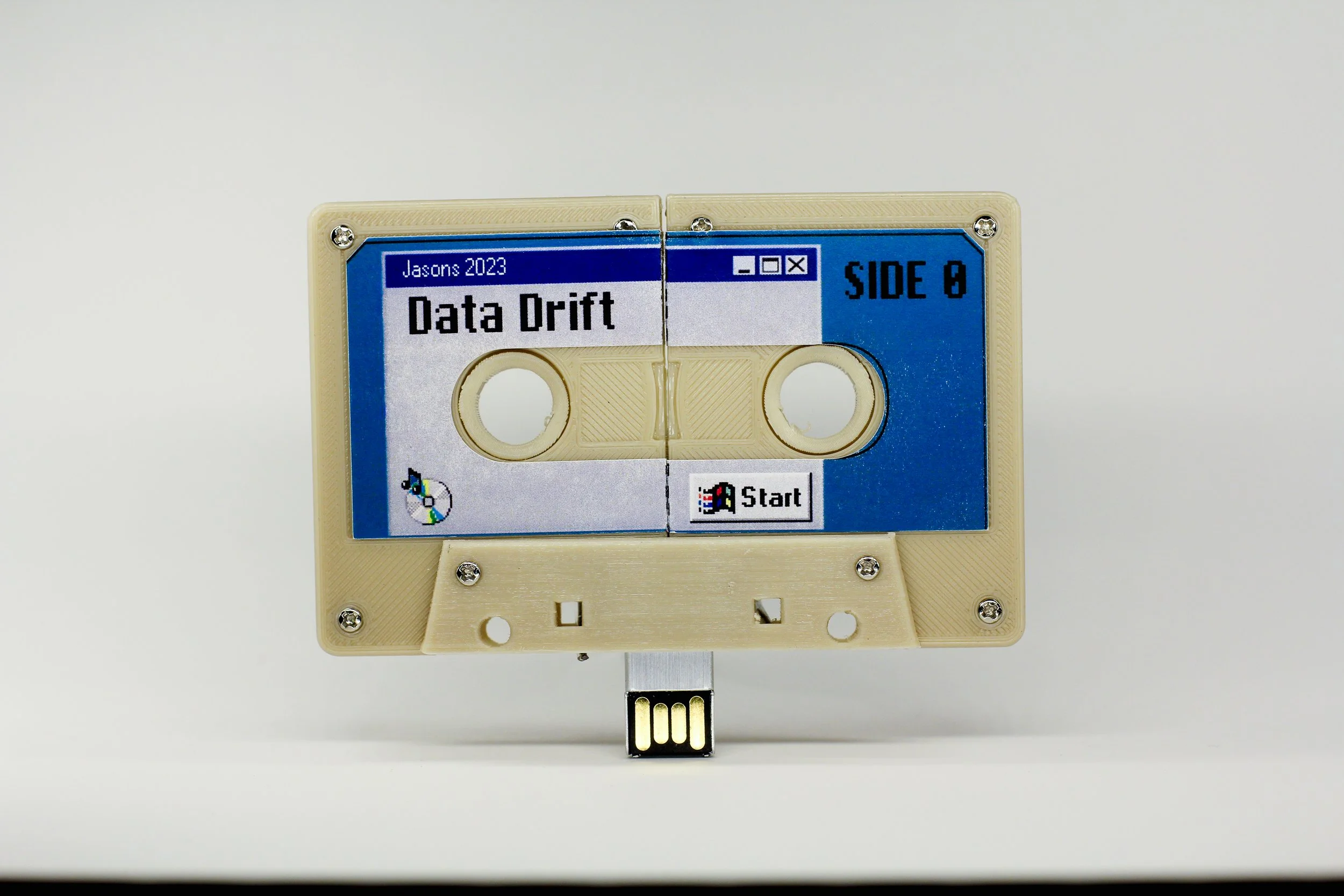 Data Drift by Jason Nuttle and Jason Salvant -

This re-designed cassette tape shell features a USB drive that extends from the bottom as the user manually spins the spools. Taking inspiration from Basinski's Disintigration Loops, Nuttle and Salvant 
