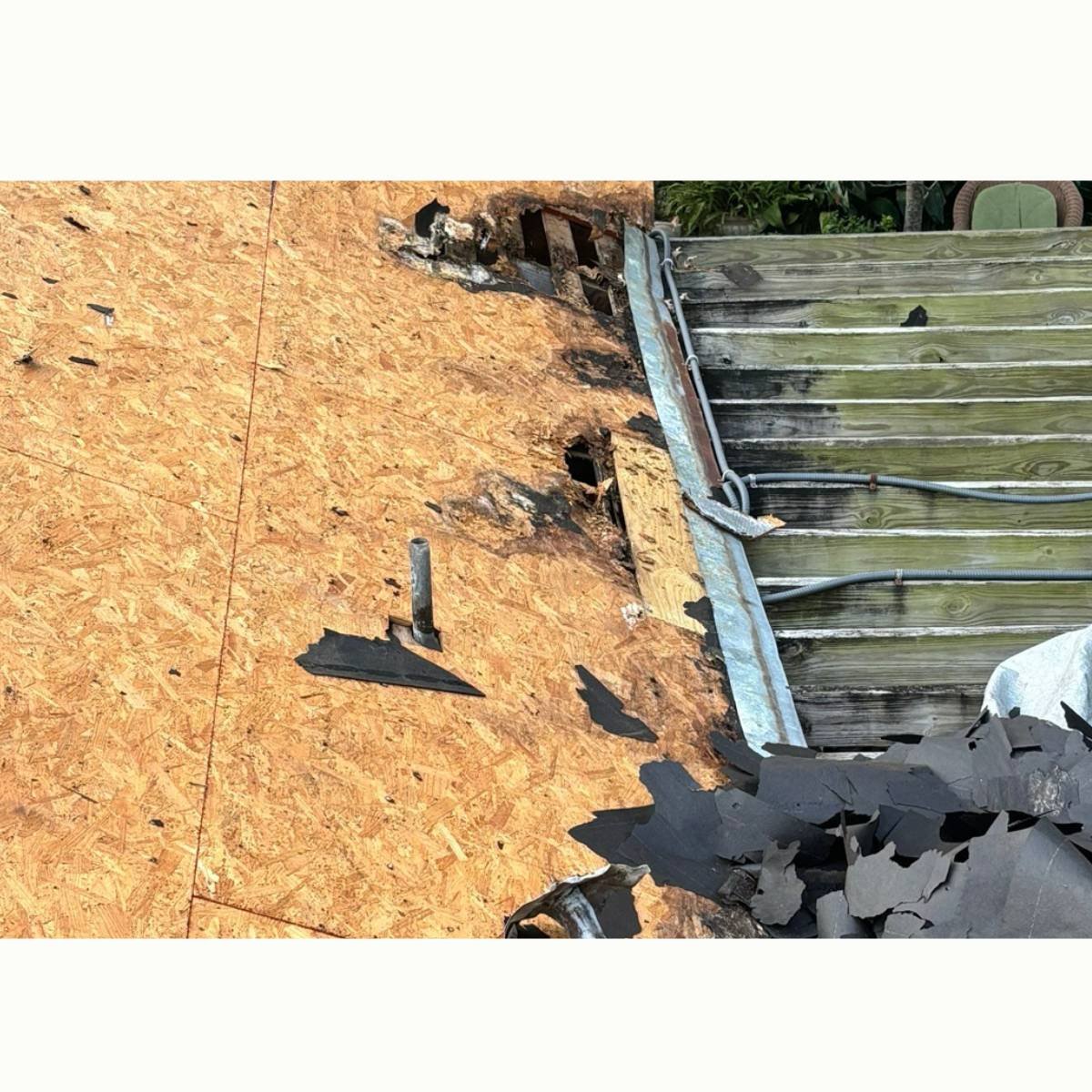 Tearing shingles off of a Houston area home for a complete roof replacement by Parker James roofing